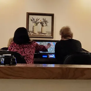 Bartender playing customers machine.