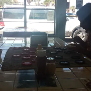 Kids having fun playing checkers as their eating dessert