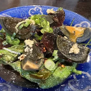 a blue plate with a salad on it