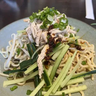 a plate of noodles and chicken