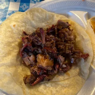 a tortilla on a paper plate
