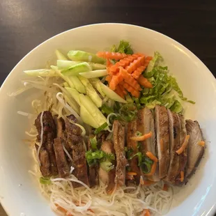 This is charbroiled chicken with carrots, cucumbers, bean sprouts and noodles