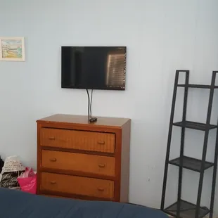 Tv , shelf and dresser.