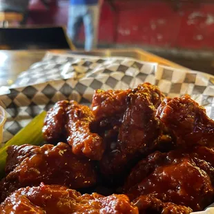 a basket of chicken wings and a pickle