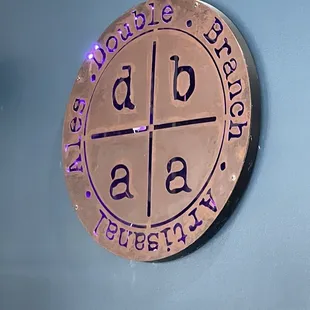 he logo on the wall