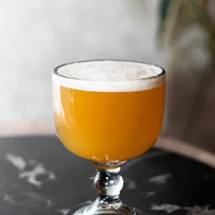 a glass of beer on a table