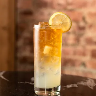 a glass of lemonade with a slice of lemon