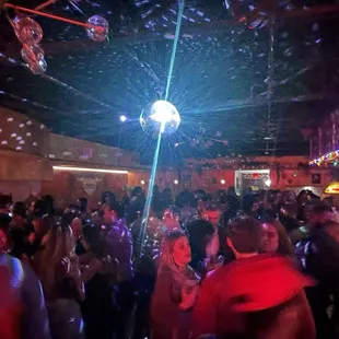 a crowd of people dancing at a party