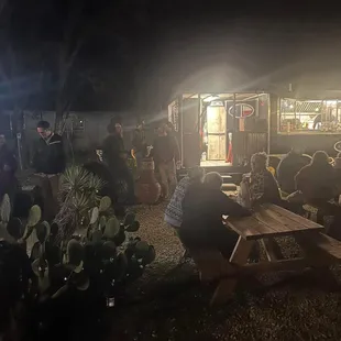 a group of people sitting at picnic tables