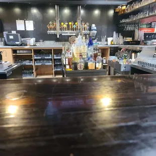 a bar counter with bottles of alcohol