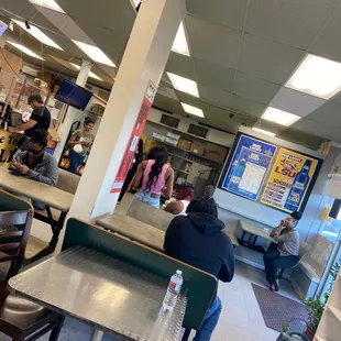people sitting at tables in a restaurant
