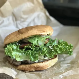 a hamburger with lettuce and tomato