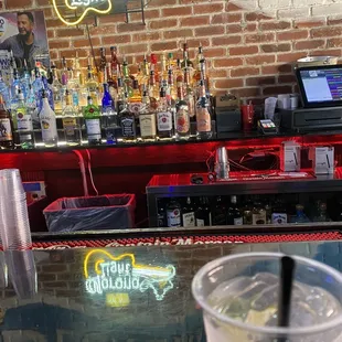 a drink in a plastic cup on a bar