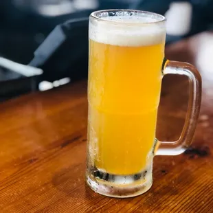 a glass of beer on a wooden table