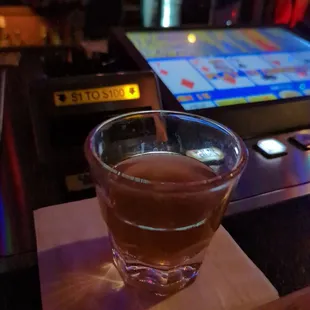 a shot of a drink in a glass