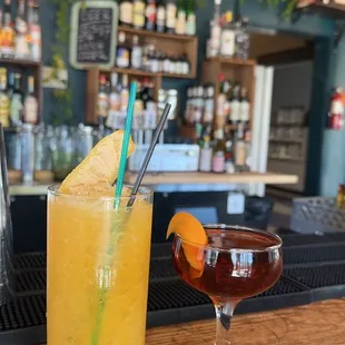 two cocktails on a bar