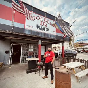 a man standing in front of a barrel