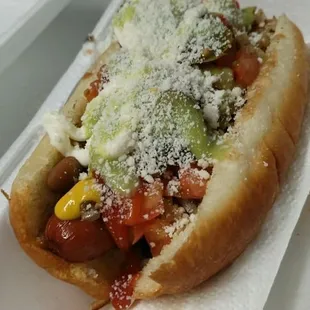 Sonoran style hot dog

bacon-wrapped ALL beef hot dog on delicious bread with guacamole, ketchup, mustard, mayo, hot sauce and cotija cheese