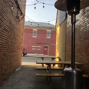 a patio with tables and a firepit