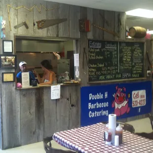Order counter- cool old tools tacked onto reclaimed barn wood