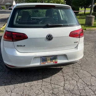 the rear end of a white volkswagen golf