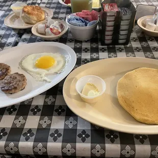 One hot cake with sausage and one sunny side up egg