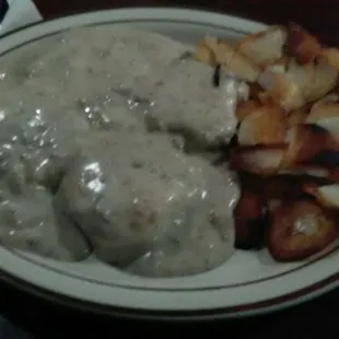 Biscuits and gravy with fried potatoes.
