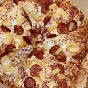 Pizza with pepperoni and pineapple