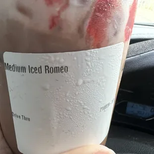 a hand holding a cup of coffee