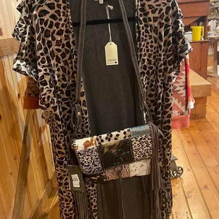 a leopard print coat hanging on a rack