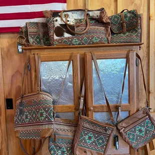 a collection of purses on a shelf