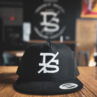 a black hat with a white logo