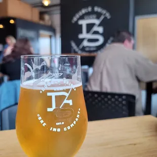 a glass of beer on a table