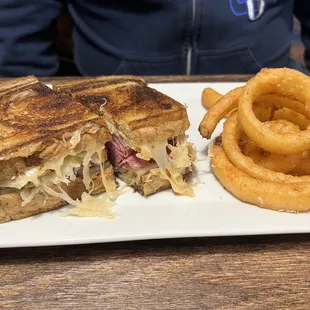 a sandwich and onion rings on a plate
