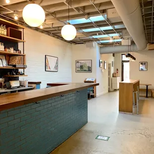 a coffee shop with a blue brick counter