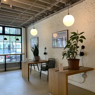 an office with a desk and a potted plant