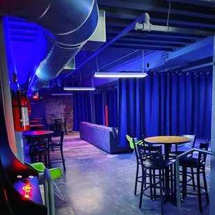a room with blue curtains and a table and chairs