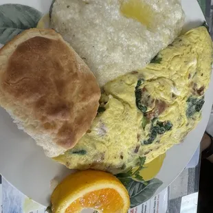 Spinach omelette with grits and biscuit.