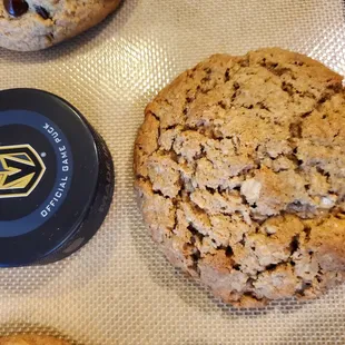 a chocolate chip cookie and a cookie tin
