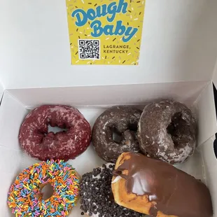 dozen donuts - red velvet cake, chocolate cake, chocolate with sprinkles, chocolate chip, and chocolate covered white fluff