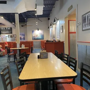 a dining area with tables and chairs