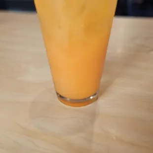 Trip to the beach - coconut peach drink with Malibu Rum, Peach Schnapps, Vodka, OJ, pineapple,  and a splash of cranberry