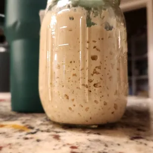 a jar of dough on a counter