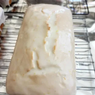 a row of glazed loafs on a cooling rack