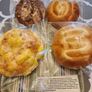 Dark chocolate almond cookie, custard bread, melon bread, and sweet cream bread.