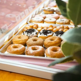 a variety of doughnuts in a display case