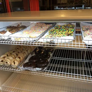 Top left to right then second level.  Maple bacon, fruity pebbles, m&amp;m, chocolate frosted with sprinkles, sour cream, chocolate frosted.