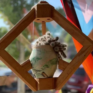 a wooden birdhouse hanging from a tree