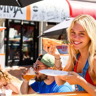 Guests dining on outdoor patio at Dough Momma Pizzeria.