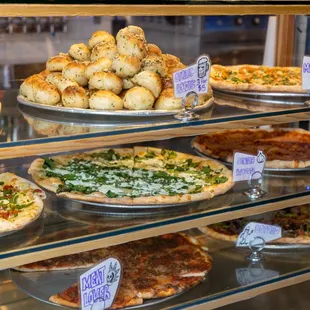 Dough Momma Display Case with Pizza and Garlic Knots.